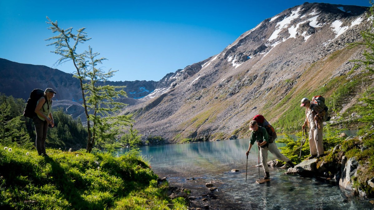 Hikers crossing a mountain stream