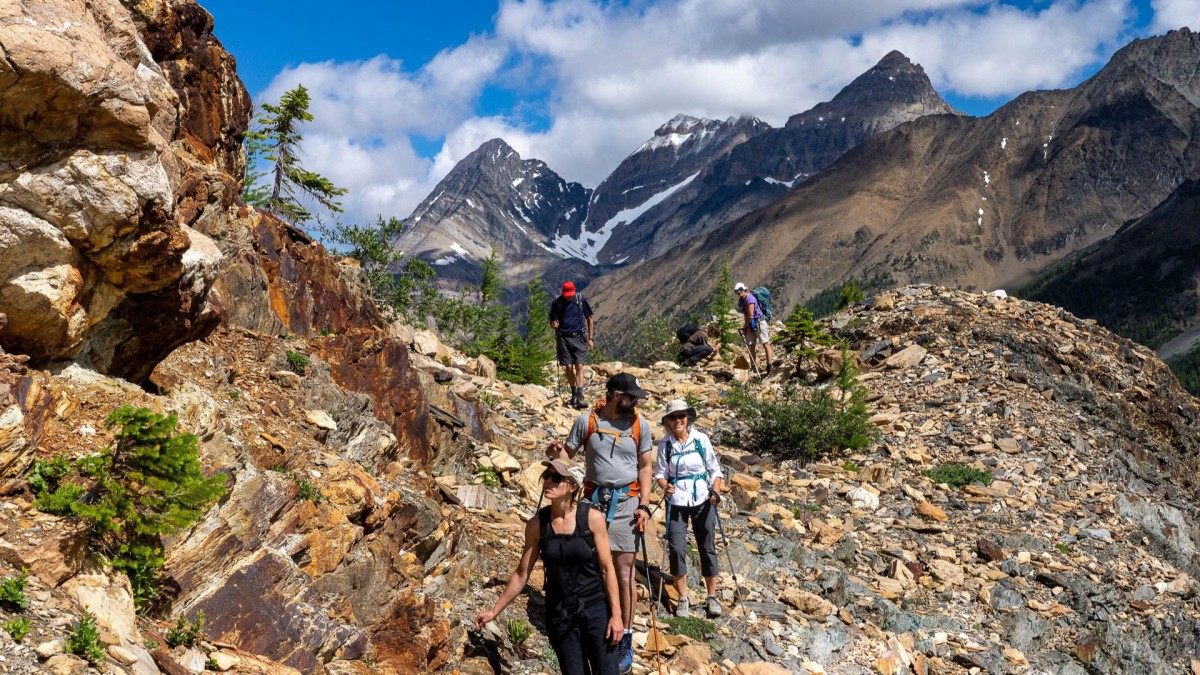 Four hikers in rocky mountainous terrain