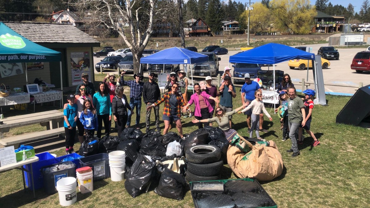 group of volunteers with a large pile of garbage bags