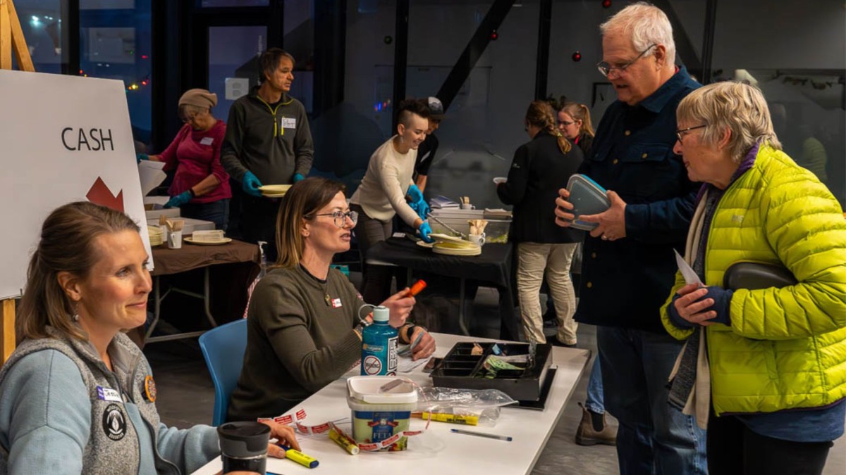 Photo of volunteers selling tickets and serving food to film fest patrons