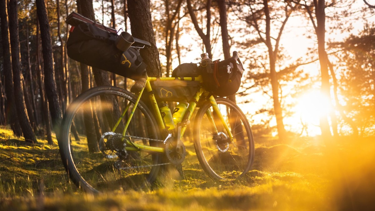 mountain bike and camping gear in golden sunlight